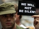 Gay soldier holding sign saying we will not be silent